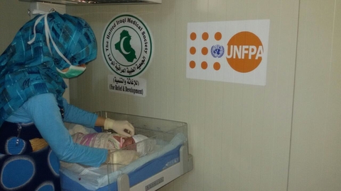A health provider checking on a newly born baby in Habbaniya Delivery room,  Anbar Governorate, Central Iraq